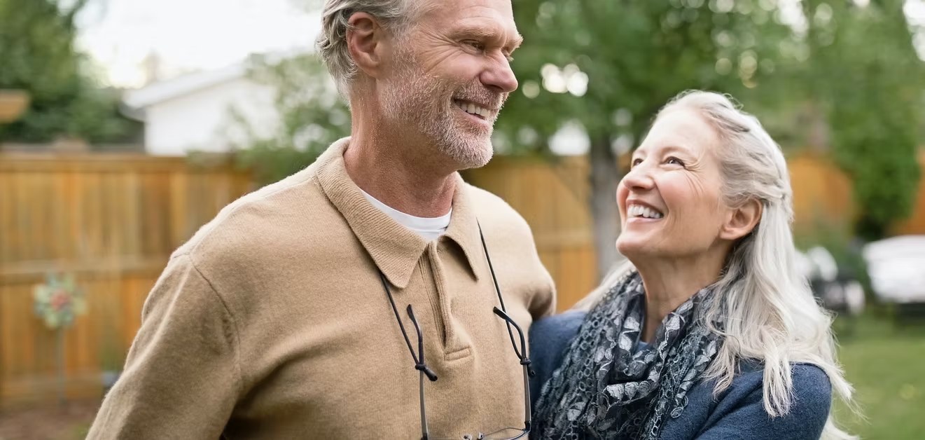 Smiling older couple embracing outdoors